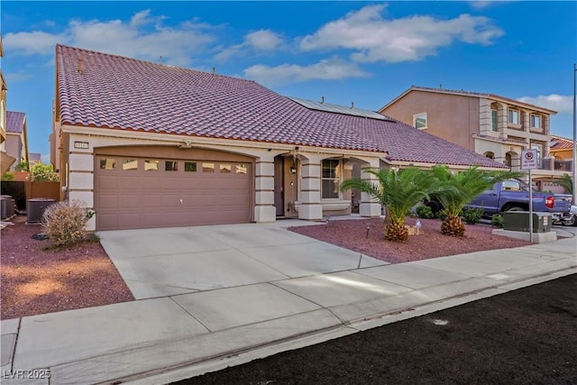 10167 Bishops Peak Ct, Las Vegas, NV 89141 - mediterranean / spanish-style home featuring stucco siding, a tiled roof, roof mounted solar panels, concrete driveway, and a garage