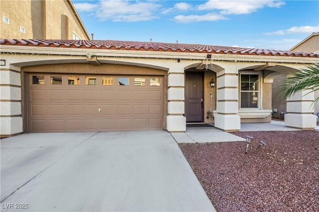 10167 Bishops Peak Ct, Las Vegas, NV 89141 - mediterranean / spanish-style home featuring driveway, a tiled roof, a garage, and stucco siding