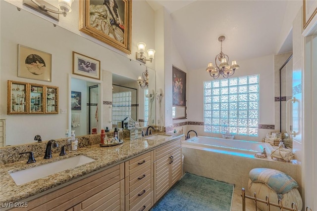 5046 Crooked Stick Way, Las Vegas, NV 89113 - full bathroom featuring a chandelier, a bath, a shower stall, double vanity, and lofted ceiling