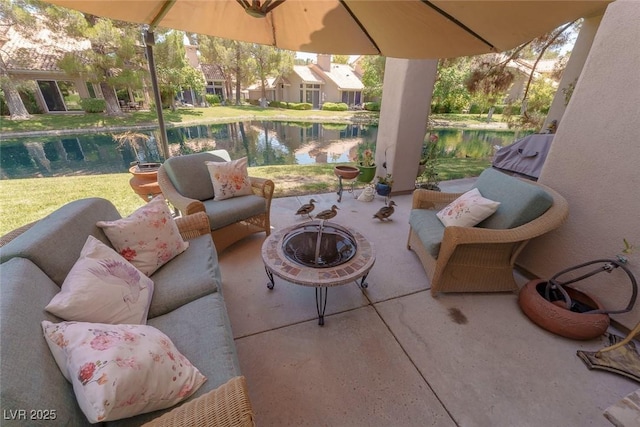 5046 Crooked Stick Way, Las Vegas, NV 89113 - view of patio / terrace featuring an outdoor living space with a fire pit and a water view