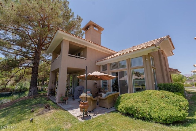 5046 Crooked Stick Way, Las Vegas, NV 89113 - rear view of house with a chimney, a tiled roof, a patio, stucco siding, and a balcony