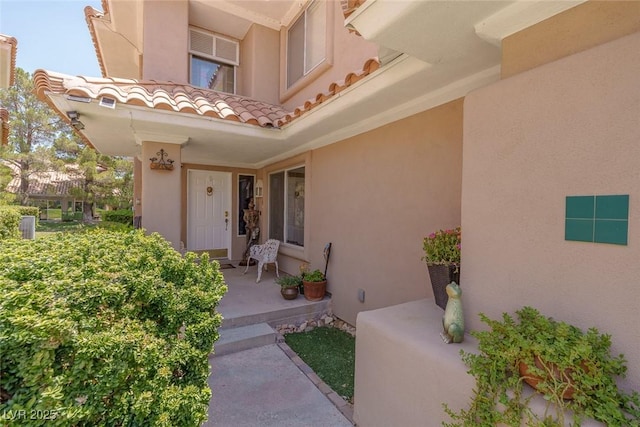 5046 Crooked Stick Way, Las Vegas, NV 89113 - view of exterior entry with stucco siding and a tile roof