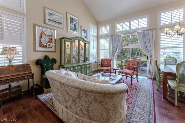 5046 Crooked Stick Way, Las Vegas, NV 89113 - living area featuring a chandelier, dark wood-style flooring, healthy amount of natural light, and high vaulted ceiling