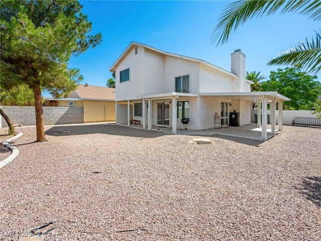 3740 Broadriver Dr, Las Vegas, NV 89108 - back of house with a patio, stucco siding, and a chimney