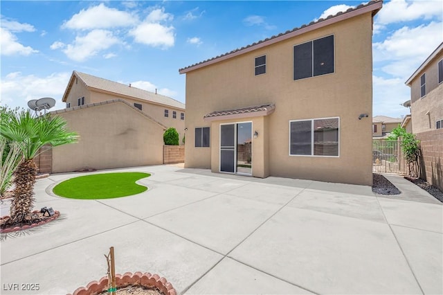 11010 Santorini Dr, Las Vegas, NV 89141 - rear view of property featuring stucco siding, a fenced backyard, a patio, and a tile roof