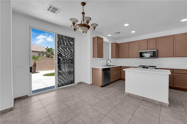 11010 Santorini Dr, Las Vegas, NV 89141 - kitchen featuring appliances with stainless steel finishes, a chandelier, light countertops, recessed lighting, and pendant lighting