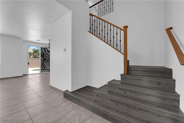11010 Santorini Dr, Las Vegas, NV 89141 - stairs with tile patterned flooring and a high ceiling