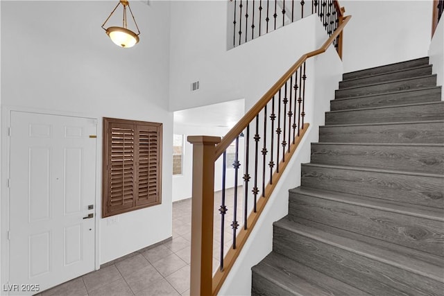 11010 Santorini Dr, Las Vegas, NV 89141 - entrance foyer featuring a towering ceiling, stairs, and tile patterned floors