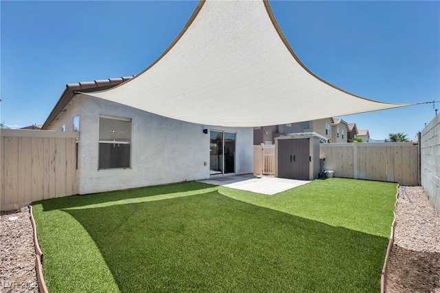 4020 Pistachio Nut Ave, Las Vegas, NV 89115 - rear view of house featuring a fenced backyard, stucco siding, a patio area, and a storage unit