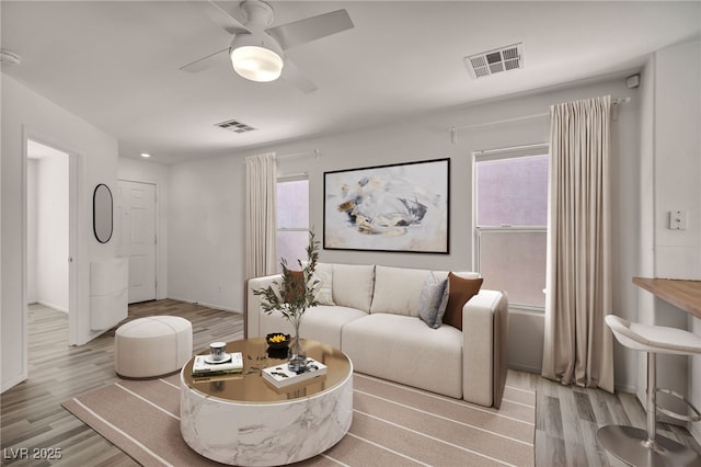 4020 Pistachio Nut Ave, Las Vegas, NV 89115 - living area featuring wood finished floors, healthy amount of natural light, and a ceiling fan