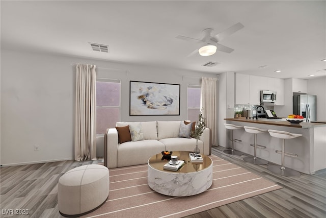 4020 Pistachio Nut Ave, Las Vegas, NV 89115 - living room with light wood-style flooring, healthy amount of natural light, a ceiling fan, and recessed lighting