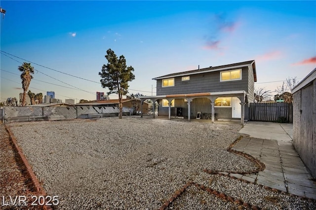 3208 Alcoa Ave, Las Vegas, NV 89102 - back of house at dusk with a patio area and a fenced backyard