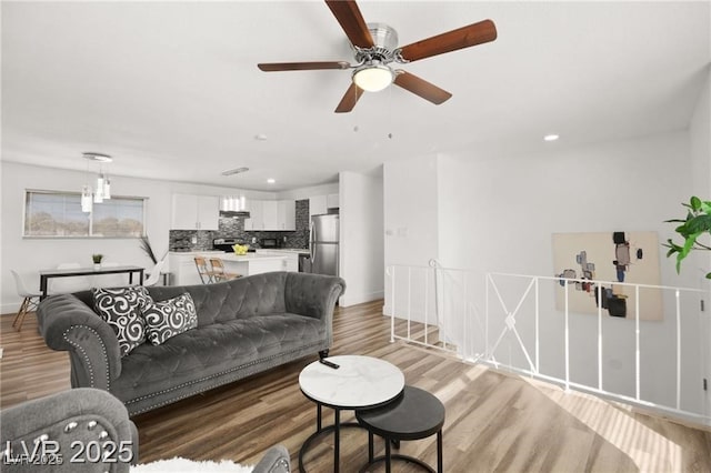 3208 Alcoa Ave, Las Vegas, NV 89102 - living area featuring light wood-style flooring, ceiling fan, and recessed lighting