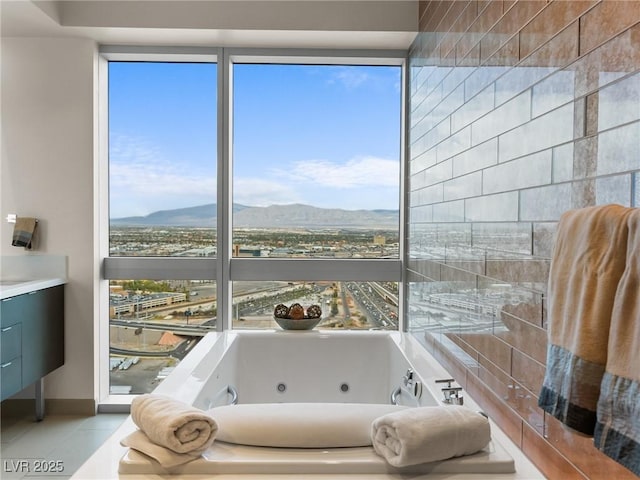 4471 Dean Martin Dr Unit 4308, Las Vegas, NV 89103 - bathroom featuring a mountain view, a whirlpool tub, vanity, and tile patterned flooring