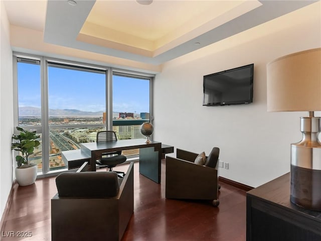4471 Dean Martin Dr Unit 4308, Las Vegas, NV 89103 - living area with healthy amount of natural light, a tray ceiling, a desk, and wood finished floors