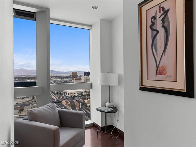 4471 Dean Martin Dr Unit 4308, Las Vegas, NV 89103 - living area featuring floor to ceiling windows, wood finished floors, and a mountain view