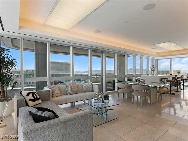 4471 Dean Martin Dr Unit 4308, Las Vegas, NV 89103 - living room featuring a tray ceiling, light tile patterned floors, and expansive windows