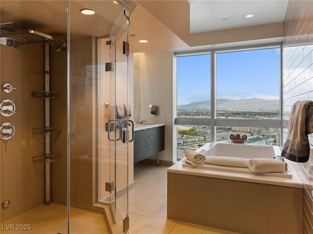 4471 Dean Martin Dr Unit 4308, Las Vegas, NV 89103 - bathroom featuring a mountain view, a stall shower, a bath, and recessed lighting