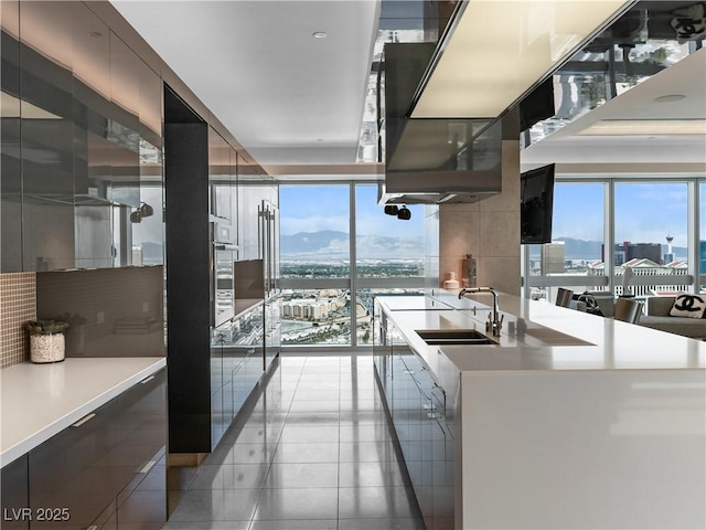 4471 Dean Martin Dr Unit 4308, Las Vegas, NV 89103 - kitchen featuring modern cabinets, light tile patterned flooring, healthy amount of natural light, and light countertops