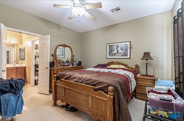 3109 Frigate Way N, Las Vegas, NV 89084 - bedroom with light colored carpet, a ceiling fan, and connected bathroom