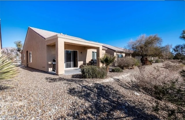 3109 Frigate Way N, Las Vegas, NV 89084 - rear view of house featuring stucco siding and a patio area