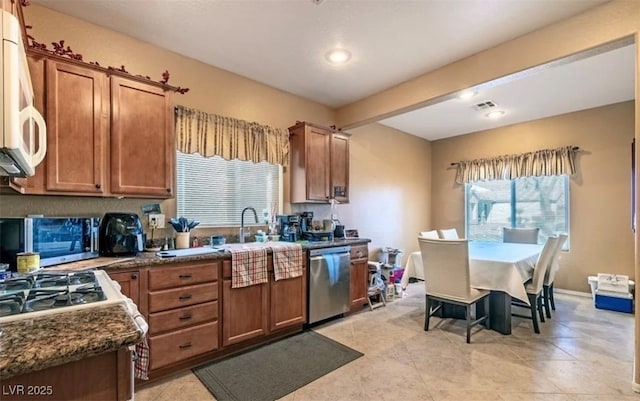 3109 Frigate Way N, Las Vegas, NV 89084 - kitchen with dishwasher, white microwave, brown cabinetry, beamed ceiling, and recessed lighting