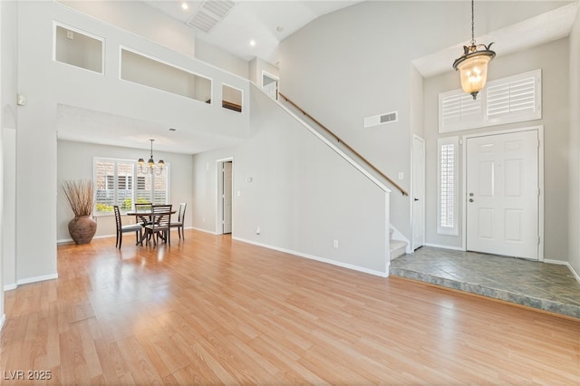 1337 Maplegrove Cir, Las Vegas, NV 89108 - foyer featuring a high ceiling, a chandelier, light wood-type flooring, stairs, and recessed lighting