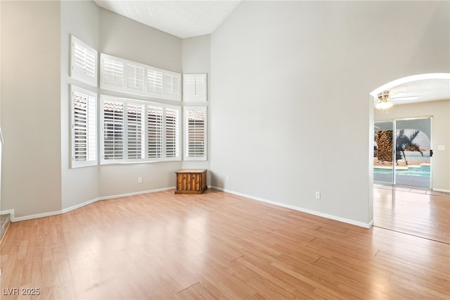 1337 Maplegrove Cir, Las Vegas, NV 89108 - unfurnished room with light wood-style floors, ceiling fan, and a high ceiling