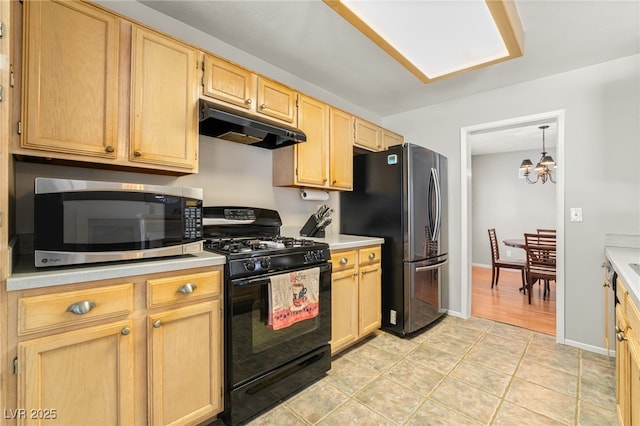 1337 Maplegrove Cir, Las Vegas, NV 89108 - kitchen featuring stainless steel microwave, gas stove, under cabinet range hood, freestanding refrigerator, and light countertops