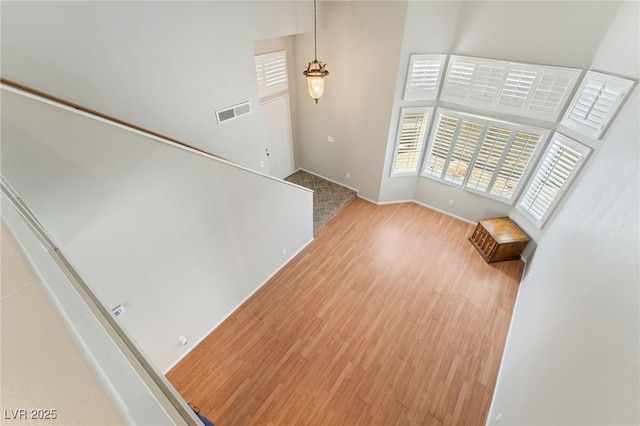 1337 Maplegrove Cir, Las Vegas, NV 89108 - unfurnished living room with wood finished floors and a towering ceiling