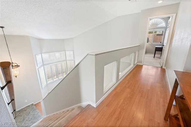 1337 Maplegrove Cir, Las Vegas, NV 89108 - hall with light wood finished floors, an upstairs landing, a textured ceiling, and lofted ceiling