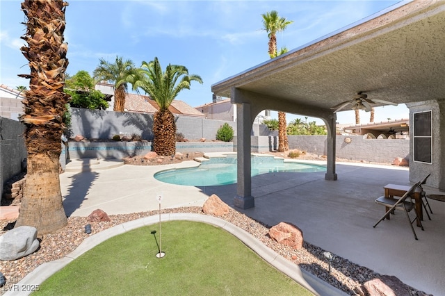 1337 Maplegrove Cir, Las Vegas, NV 89108 - view of swimming pool with a putting green, a ceiling fan, a fenced backyard, and a patio