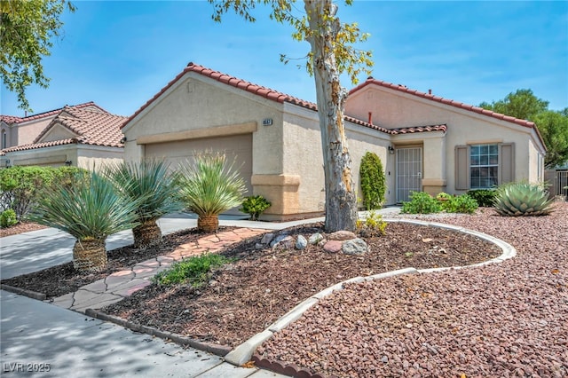 8557 Hidden Pines Ave, Las Vegas, NV 89143 - mediterranean / spanish house with stucco siding, an attached garage, and a tiled roof