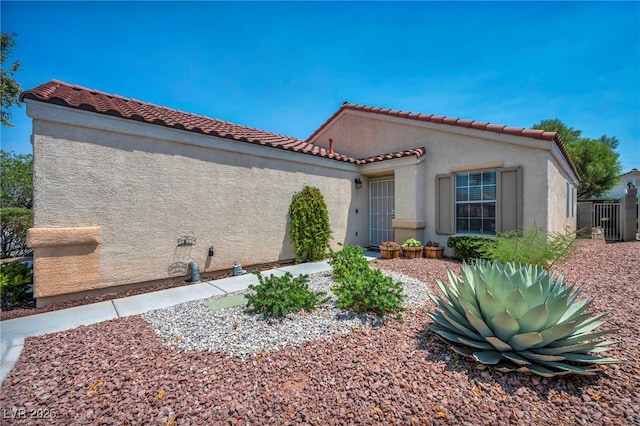 8557 Hidden Pines Ave, Las Vegas, NV 89143 - view of property exterior with stucco siding and a tiled roof
