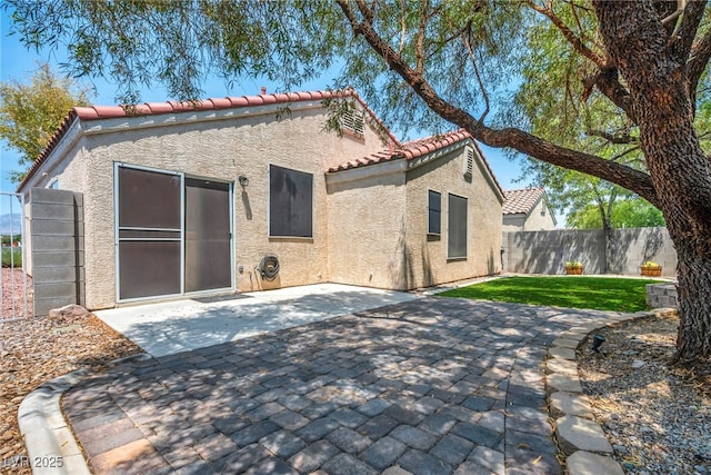 8557 Hidden Pines Ave, Las Vegas, NV 89143 - rear view of house with stucco siding, a tile roof, and a patio area