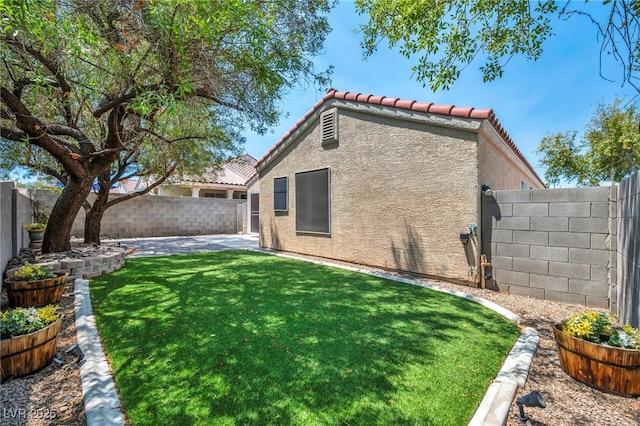 8557 Hidden Pines Ave, Las Vegas, NV 89143 - rear view of house with stucco siding, a tiled roof, a fenced backyard, and a patio area