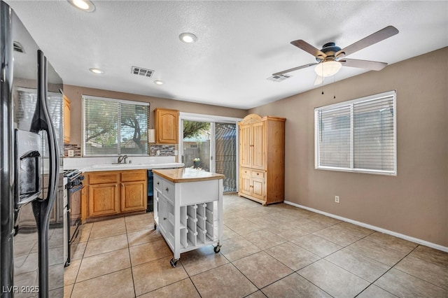 8557 Hidden Pines Ave, Las Vegas, NV 89143 - kitchen featuring black appliances, light countertops, ceiling fan, a textured ceiling, and recessed lighting