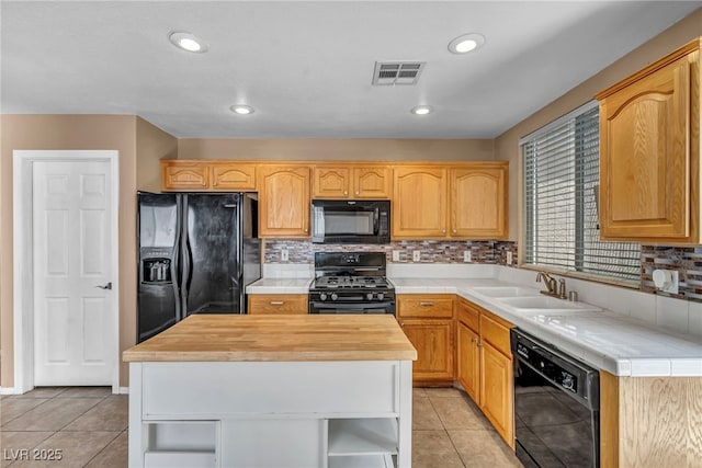 8557 Hidden Pines Ave, Las Vegas, NV 89143 - kitchen with black appliances, open shelves, a center island, tasteful backsplash, and wood counters