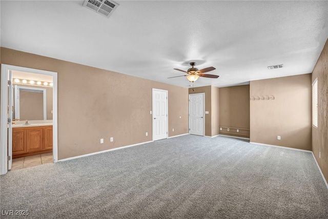 8557 Hidden Pines Ave, Las Vegas, NV 89143 - unfurnished bedroom with light colored carpet, connected bathroom, and ceiling fan
