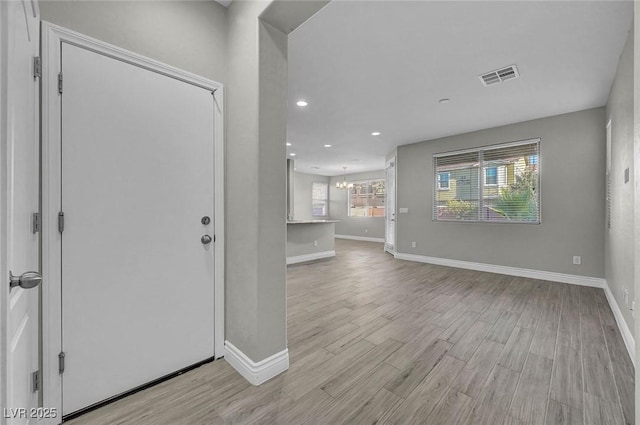 6373 Beavertail Pond Ave, Las Vegas, NV 89122 - foyer entrance featuring light wood-type flooring, a chandelier, and recessed lighting