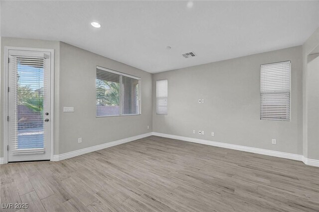 6373 Beavertail Pond Ave, Las Vegas, NV 89122 - empty room with plenty of natural light, wood finished floors, and recessed lighting