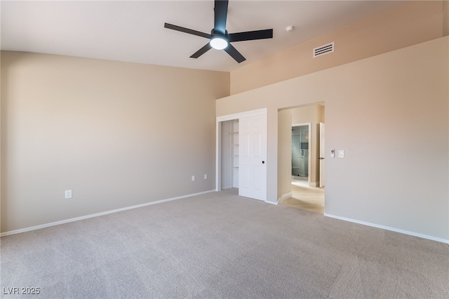 8904 Marble Dr, Las Vegas, NV 89134 - unfurnished bedroom with light colored carpet, a closet, vaulted ceiling, and a ceiling fan