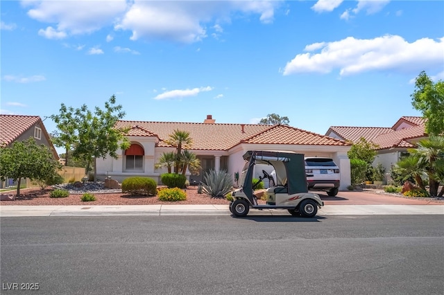 8904 Marble Dr, Las Vegas, NV 89134 - mediterranean / spanish house with a tiled roof, a chimney, an attached garage, concrete driveway, and stucco siding