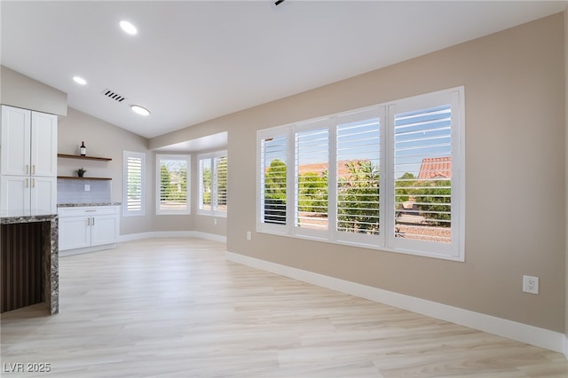 8904 Marble Dr, Las Vegas, NV 89134 - unfurnished living room with lofted ceiling, light wood-style flooring, and recessed lighting