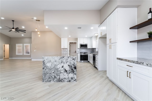 8904 Marble Dr, Las Vegas, NV 89134 - kitchen featuring appliances with stainless steel finishes, tasteful backsplash, ceiling fan, light wood-type flooring, and recessed lighting