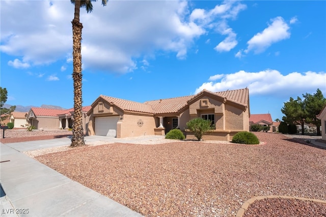 8904 Marble Dr, Las Vegas, NV 89134 - mediterranean / spanish-style home featuring stucco siding, a tiled roof, driveway, and a garage