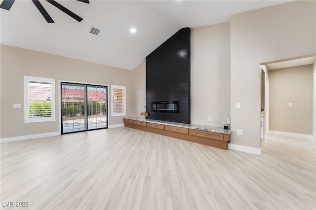 8904 Marble Dr, Las Vegas, NV 89134 - unfurnished living room featuring high vaulted ceiling, ceiling fan, light wood-style flooring, a large fireplace, and recessed lighting