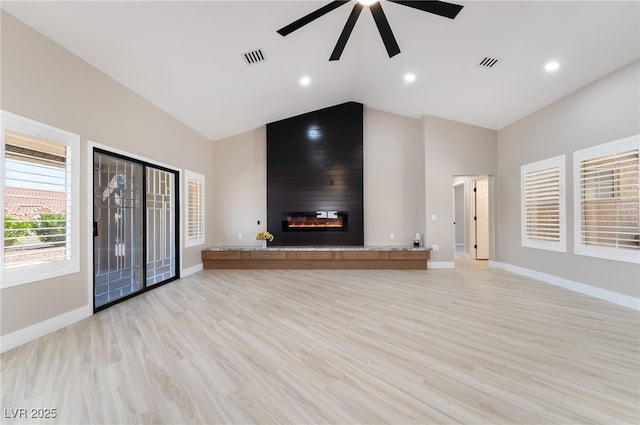 8904 Marble Dr, Las Vegas, NV 89134 - unfurnished living room with ceiling fan, light wood-type flooring, a large fireplace, high vaulted ceiling, and recessed lighting