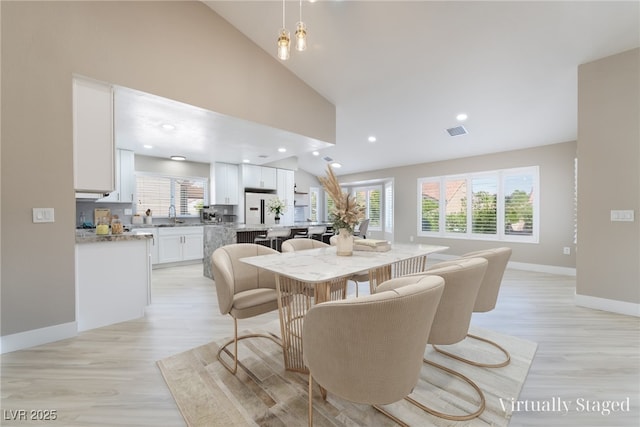 8904 Marble Dr, Las Vegas, NV 89134 - dining area with lofted ceiling, light wood-style floors, and recessed lighting