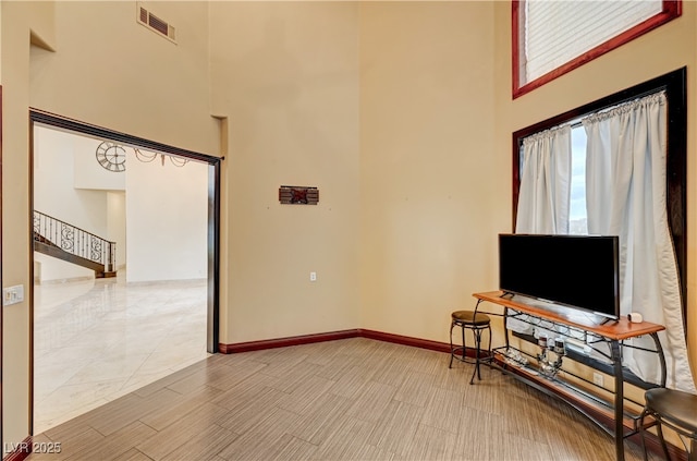 7751 Radcliff St, Las Vegas, NV 89123 - living area with a high ceiling and stairway